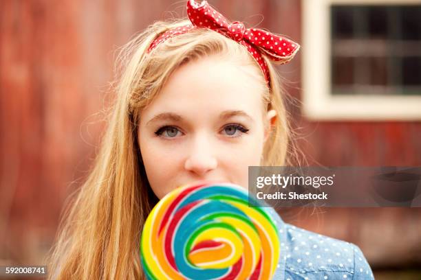 caucasian teenage girl licking lollipop - girl lollipops stock pictures, royalty-free photos & images