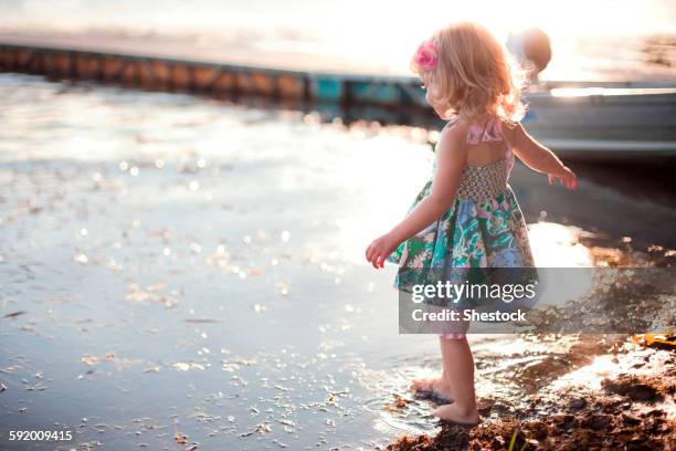girl dipping toe in rural lake - dip toe stock pictures, royalty-free photos & images