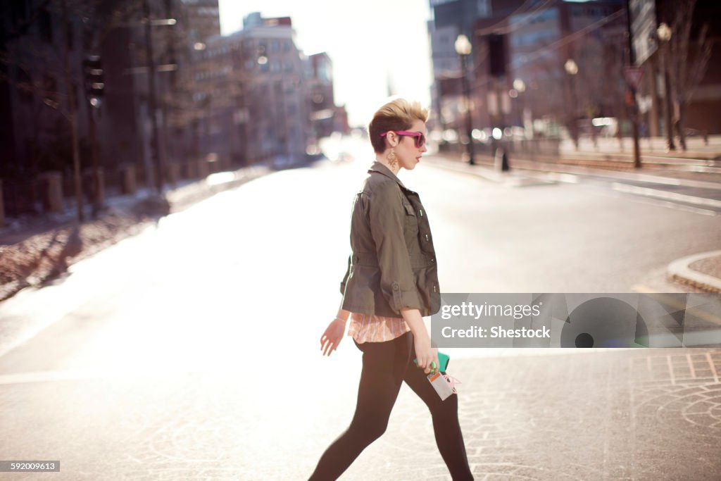 Woman walking in city intersection