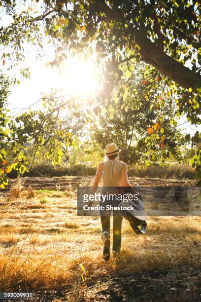 caucasian musician carrying guitar in rural field - santa rosa california stock pictures, royalty-free photos & images