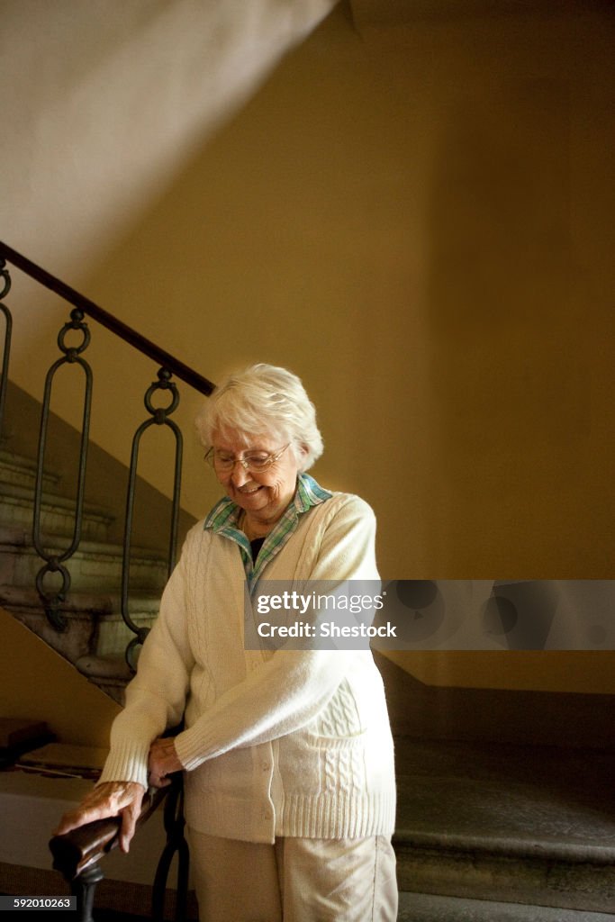 Older Caucasian woman climbing stairs