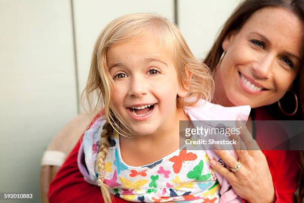 caucasian mother and daughter smiling outdoors - surprised mum stock-fotos und bilder