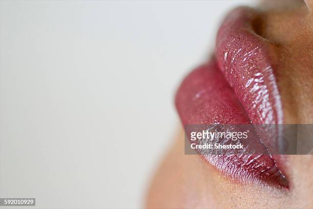 close up of woman wearing lip gloss - damp lips stock pictures, royalty-free photos & images
