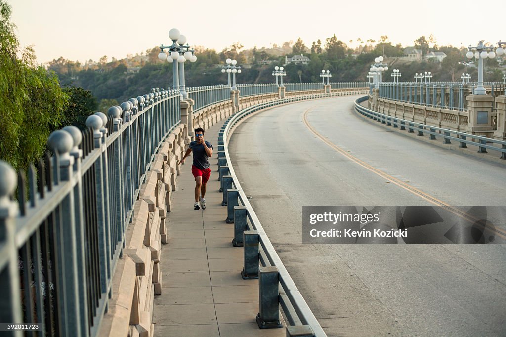 Jogger running on bridge, Arroyo Seco Park, Pasadena, California, USA