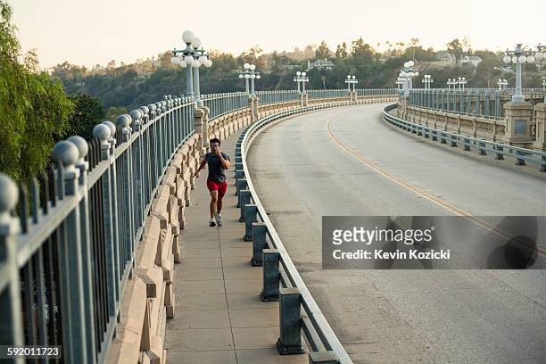 jogger running on bridge, arroyo seco park, pasadena, california, usa - pasadena california stock pictures, royalty-free photos & images