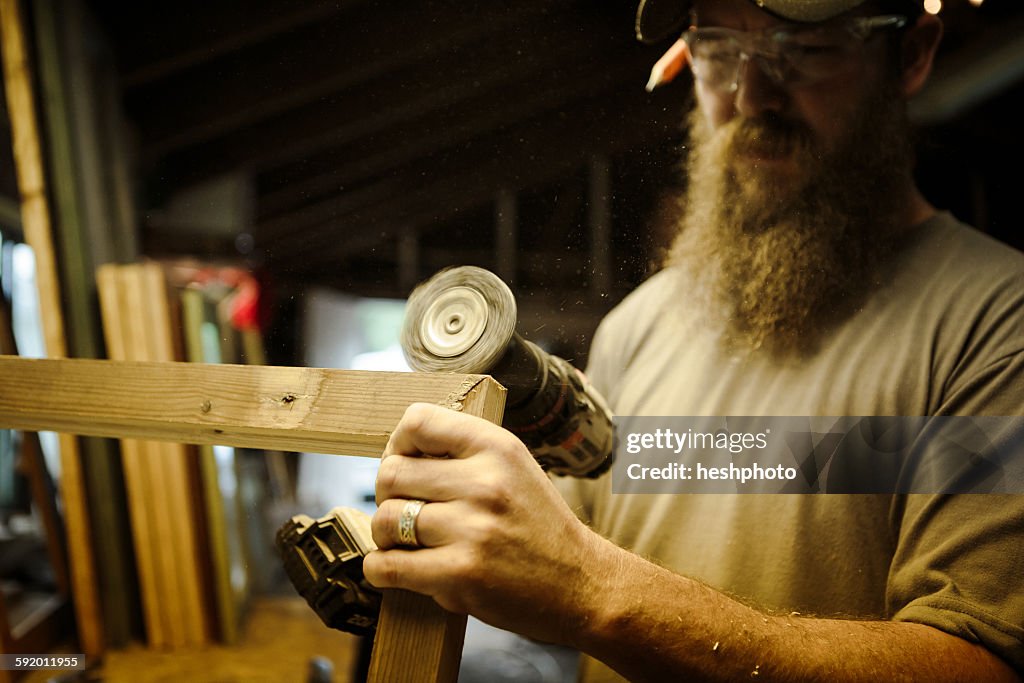 Wood artist working in workshop