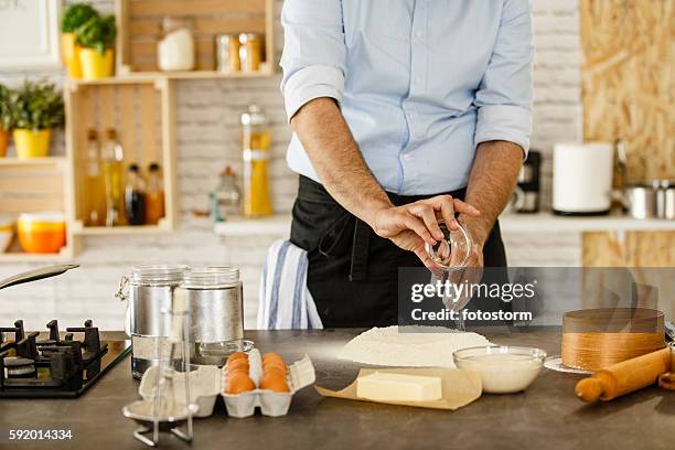 chef making dough, adding salt - add salt stock pictures, royalty-free photos & images