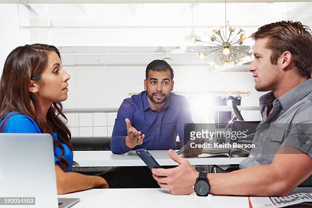 small group of people having business meeting, male and female colleagues having disagreement - schlichtung stock-fotos und bilder