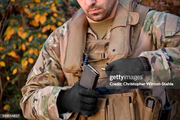 soldier loading automatic weapon during training - brown glove stock pictures, royalty-free photos & images