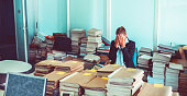Overworked office worker, bureaucracy, archives
