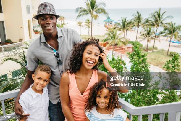 family smiling on steps overlooking beach - beach florida family stockfoto's en -beelden