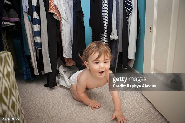 baby boy crawling, emerging from wardrobe - santa clarita stock pictures, royalty-free photos & images