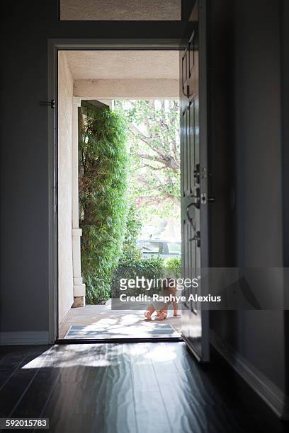 rear view of baby boy wearing nappy crawling through open front door - santa clarita stock pictures, royalty-free photos & images