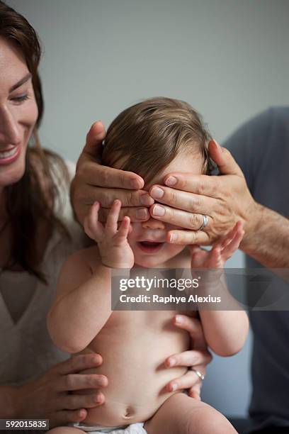 mother and father playing peek a boo with baby boy - santa clarita stock pictures, royalty-free photos & images