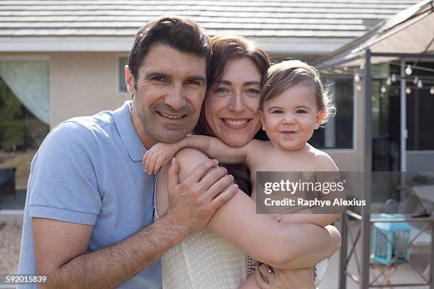 family with baby boy hugging and smiling looking at camera smiling - santa clarita stock pictures, royalty-free photos & images