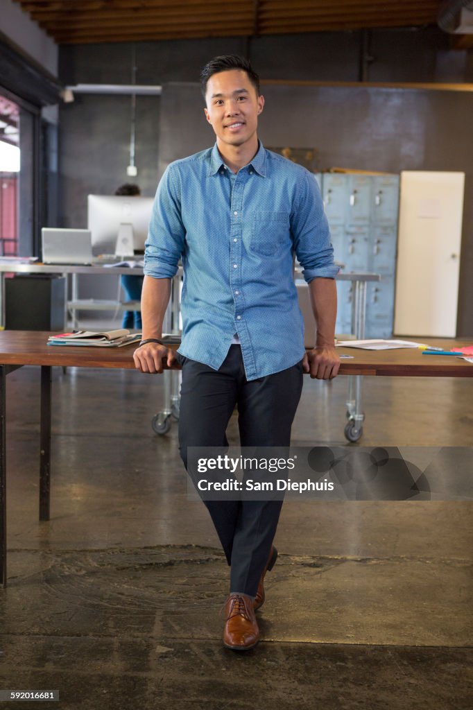 Mixed race businessman smiling in office