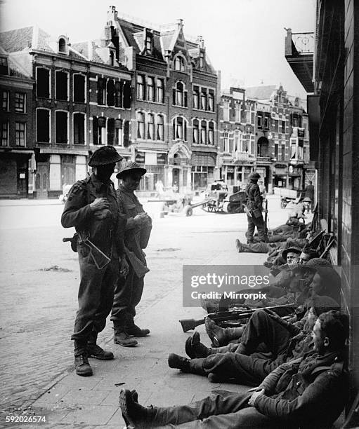 British Infantry soldiers take a rest in streets of Nijmegen after liberating the Dutch town. September 1944