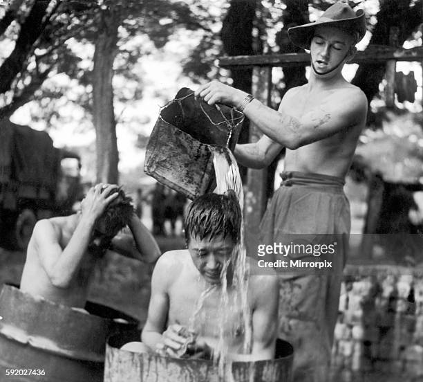Japanese Prisoners of war are washed by Lance Corporal Smith after they were taken prisoner by British forces during the last stages of the Japanese...