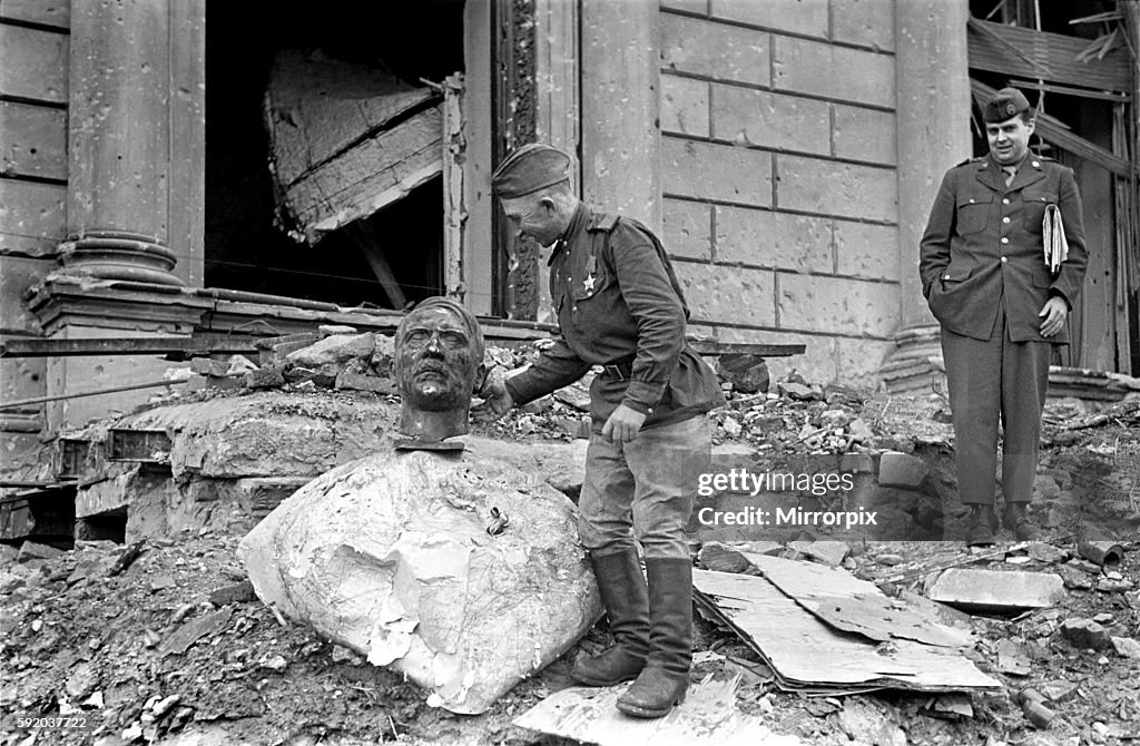Scenes at the Reichstag in Berlin showing a Russian soldier of the Red Army and an American soldier with a bronze bust o