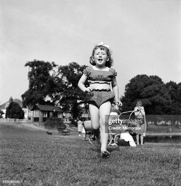 Holidays, little girl modelling swimsuit. June 1953 D3299-004