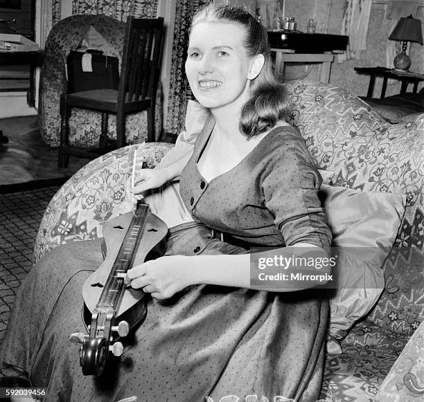 The instrument is called a mountain dulcimer and is played as an accompaniment to American folk songs with a goose quill. September 1953 D5834
