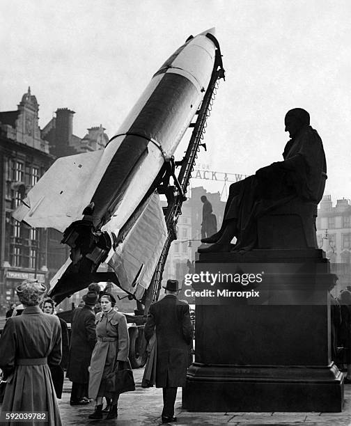 Civil Defence To stimulate recruitment for the civil defence in Manchester, a V.2. Rocket is on show in Piccadilly. Early morning workers take a look...