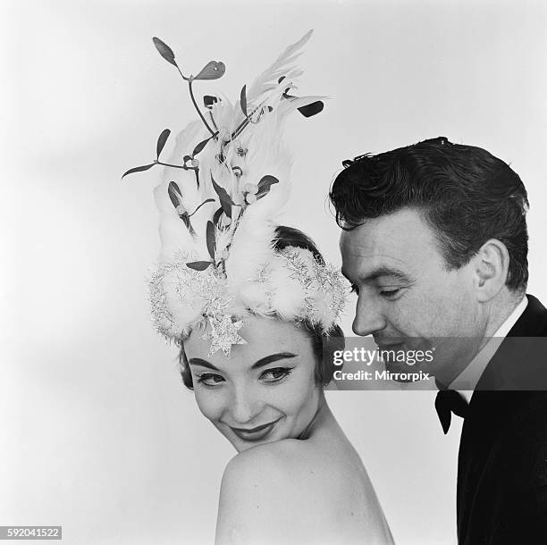 Model posing in the studio, wearing a Christmas bonnet designed by Madge Ehard. 22nd December 1957.