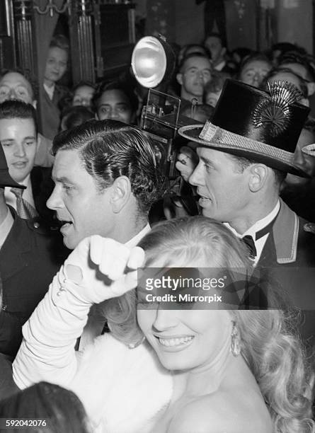 Anita Ekberg and Anthony Steele caught in the surging crowds outside the Empire Theatre Leicester Square. The couple were attending the premiere of...