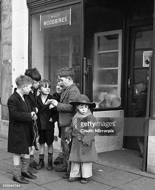 Life in the Mirror - Our Gang. 19th January 1954 A gang of boys plot todays agenda of mischief and mayhem outside a tobacconist in Bow Road in the...