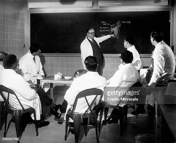 Trainee doctors being given instruction on the blackboard during a lecture. 20th April 1959.