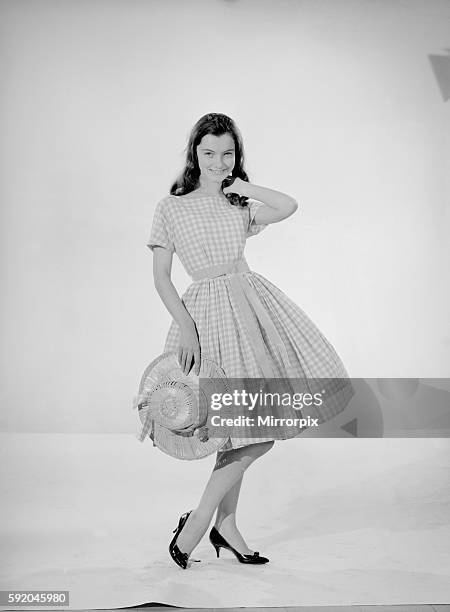 Model Jennifer Goddard. Brown-haired girl in checkered dress with hat