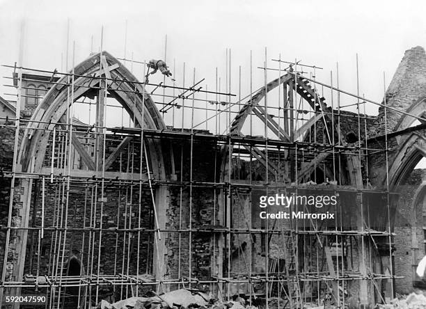 Church of St John the Evangelist, Maindee, Newport, Monmouthshire. Wales. Under reconstruction. 9th March 1951. A workman balances himself on...