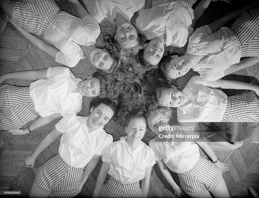 Girls of Aida Foster stage school in North London, lie down next to each other forming a circle on the floor. 18th Novem