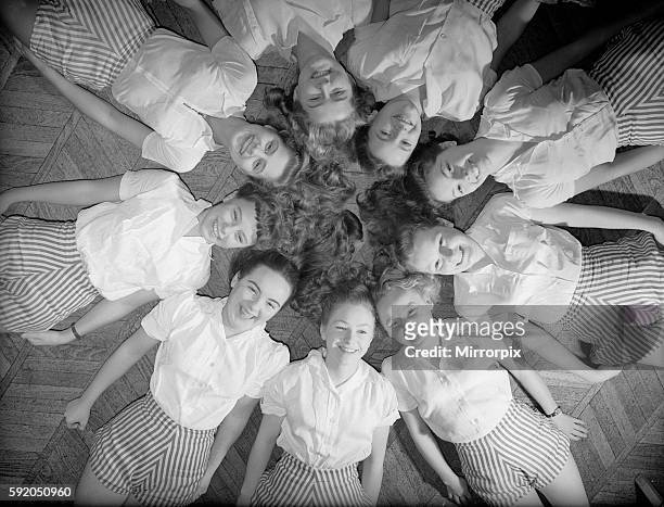 Girls of Aida Foster stage school in North London, lie down next to each other forming a circle on the floor. 18th November 1952.