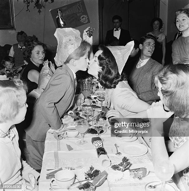 Boy actor Richard Williams kisses actress Anne Heywood on the lips underneath the mistletoe at the Women's Sunday Mirror christmas party. 22nd...