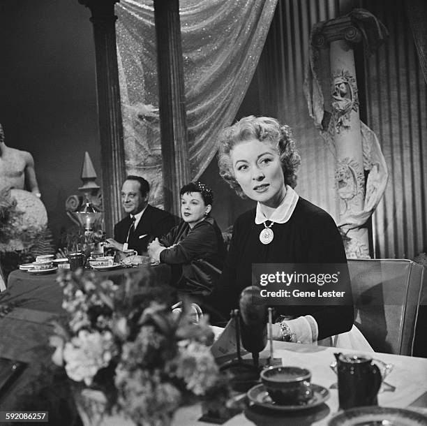 Portrait of American actress Greer Garson as she sits at a table at the 27th Academy Award nominations event, Burbank, California, February 12, 1955....