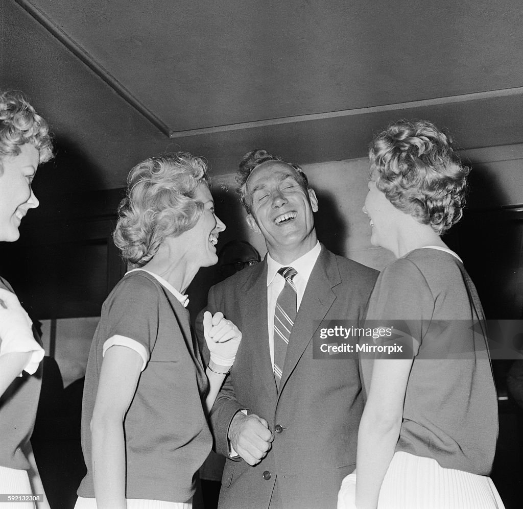 England footballer Billy Wright is greeted by his girlfriend Joy of the Beverley Sisters as he arrives at London Airport