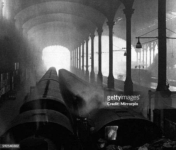At journeys end for London commuters were sights like this at Liverpool Street, more a cathedral of smog than steam in the 1950s. Trains wait by the...