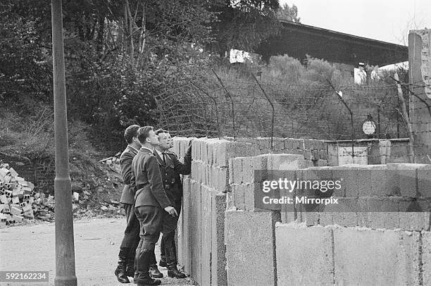 Views of the Berlin Wall with soldiers patrolling. October 1961.