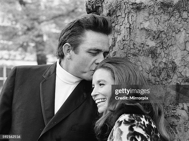 American country singer Johnny Cash with his wife June Carter photographed in a London park during their visit to Britain, a few weeks after their...