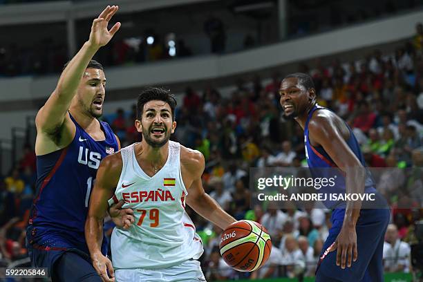 Spain's point guard Ricky Rubio jumps for the basket by USA's guard Klay Thompson during a Men's semifinal basketball match between Spain and USA at...