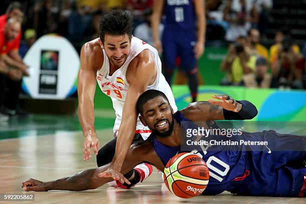 Ricky Rubio of Spain and Kyrie Irving of United States dive for the loose ball during the Men's Semifinal match on Day 14 of the Rio 2016 Olympic...