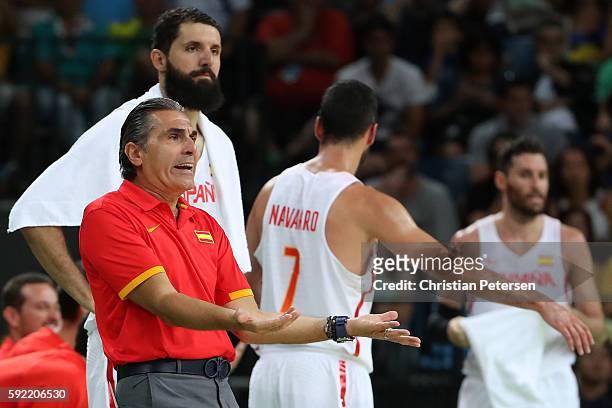 Head coach Sergio Scariolo of Spain reacts from the sideline alongside Nikola Mirotic, Juan-Carlos Navarro and Rudy Fernandez of Spain during the...
