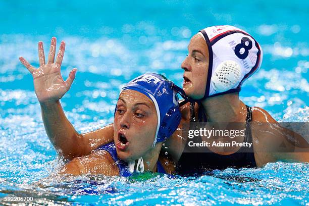 Kiley Neushul of United States and Rosaria Aiello of Italy compete in the Women's Water Polo Gold Medal Classification match between the United...