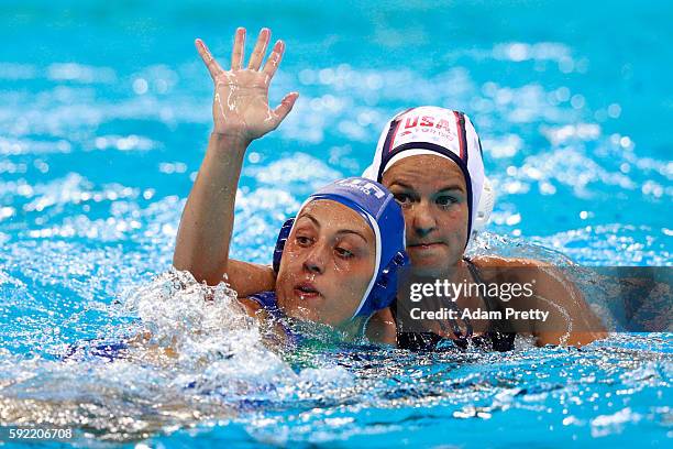 Kiley Neushul of United States and Rosaria Aiello of Italy compete in the Women's Water Polo Gold Medal Classification match between the United...