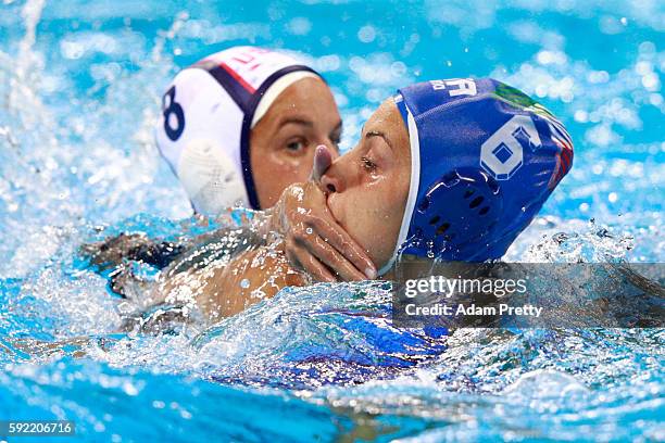 Kiley Neushul of United States and Rosaria Aiello of Italy compete in the Women's Water Polo Gold Medal Classification match between the United...