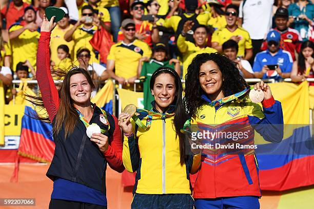 Silver medalist Alise Post of USA, gold medalist Mariana Pajon of Colombia and bronze medalist Stefany Hernandez of Venezuela on the podium after the...
