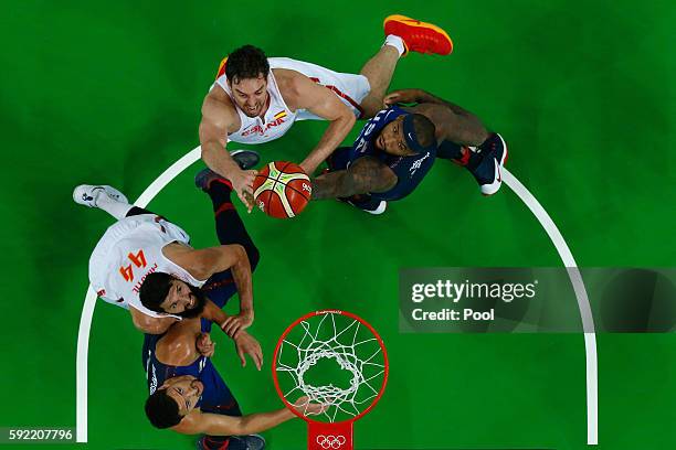 Pau Gasol of Spain goes to the basket against Demarcus Cousins and Klay Thompson of United States as Nikola Mirotic of Spain looks on during the...