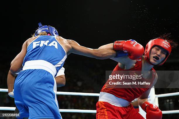 Estelle Mossely of France fights Junhua Yin of China in the Women's Light Final Bout on Day 14 of the Rio 2016 Olympic Games at the Riocentro arena...