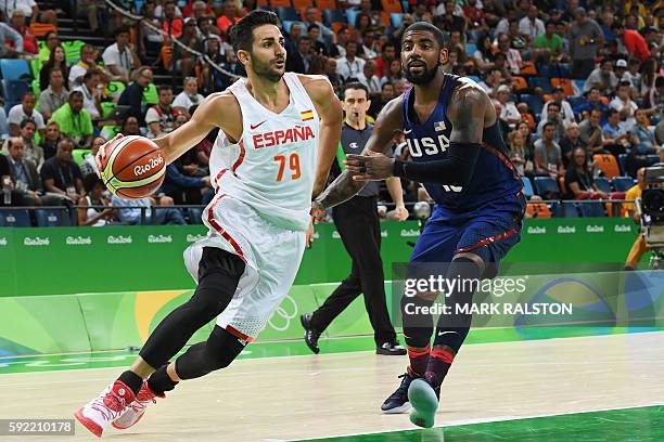 Spain's point guard Ricky Rubio runs past USA's guard Kyrie Irving during a Men's semifinal basketball match between Spain and USA at the Carioca...